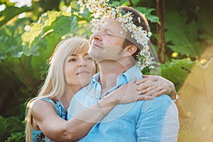 Man and woman sitting in high grass.