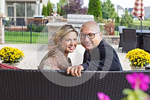 Man and woman sitting on sofa and looking back