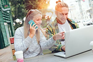 Man and woman sitting in street cafe together, business lunch brake