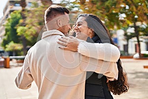 Man and woman smiling confident dancing at park