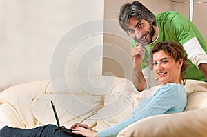 Man and Woman Smiling at Home on the Couch