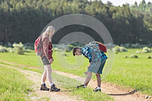 Man and woman spraying with tick repellent in nature