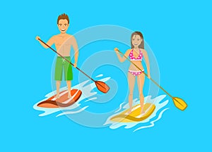 Man and woman srand up paddling, paddleboarding on water photo