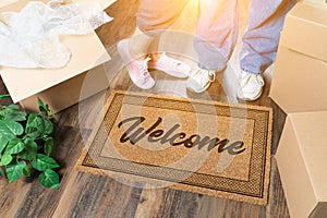 Man and Woman Standing Near Welcome Mat, Moving Boxes and Plant