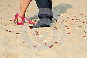 Man and woman standing on the sand