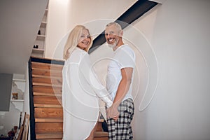 Man and woman standing on stairs and looking excited photo