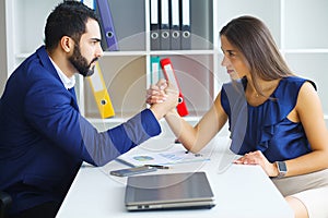 Man and woman staring at each other with hostile expressions.