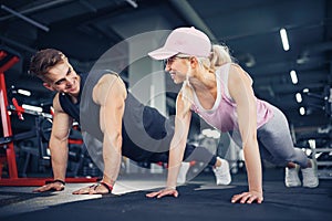 Man and woman strengthen hands at fitness training