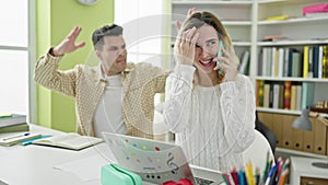 Man and woman students talking on smartphone louder disturbing at library university