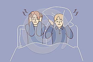 Man and woman suffering from insomnia sit in bed and cover ears with pillow due to noisy neighbors
