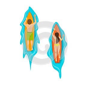 Man and woman surfers swimming on surfboards top view from above