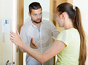 Man and woman talking at the door