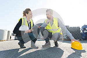 Man and woman talking in hard hats