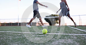 Man and woman tennis players shaking hands in middle of tennis court against background of ball and net