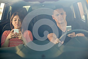 Man and woman texting and driving