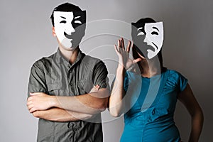 Man and woman in theatre emotions masks