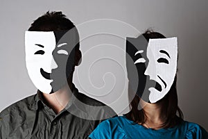Man and woman in theatre emotions masks photo