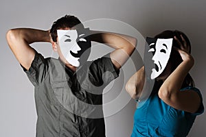 Man and woman in theatre emotions masks