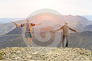 Man and woman tourists stand on the top of Poklonnaya Gora against the background of Mount Karabash