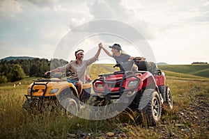 man and woman travelers with atv quad motorbike in adventure