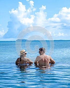 man and woman at an tropical pool, couple man and woman at swimming pool in Mauritius