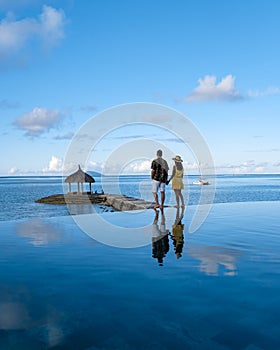 man and woman at an tropical pool, couple man and woman at swimming pool in Mauritius