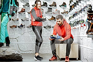 Man and woman trying shoes for hiking