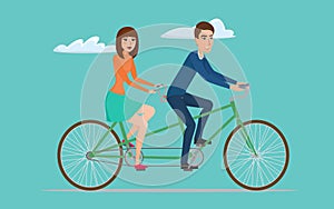 Man and woman on twin bike. Young couple riding a tandem bicycle