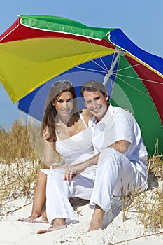 Man & Woman Under Colorful Umbrella on Beach