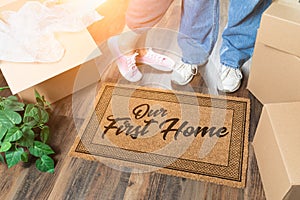 Man and Woman Unpacking Near Our First Home Welcome Mat, Moving Boxes and Plant