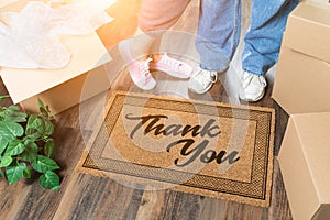 Man and Woman Unpacking Near Thank You Doo Mat, Moving Boxes and Plant