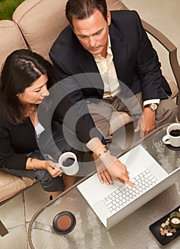 Man and Woman Using Laptop with Coffee