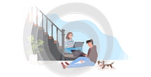 Man woman using laptops couple sitting on staircase spending time together modern hallway interior