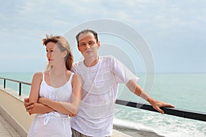 Man and woman on veranda near seacoast