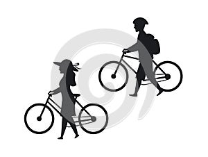 Man and woman walking with bicycles silhouettes