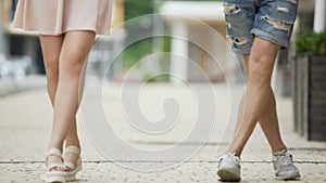 Man and woman walking simultaneously in funny way, as if dancing, happy mood