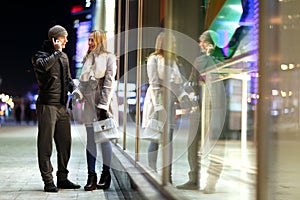 Man and woman walking at winter street photo