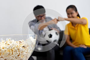 Man and woman watch Football match on tv