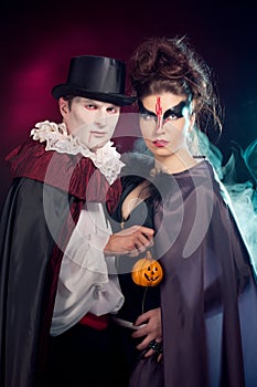 Man and woman wearing as vampire and witch. Halloween