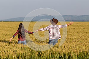 Man and woman in wheat field in summer