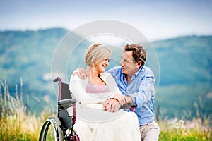 Man with woman in wheelchair