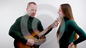 man and woman on white background romance love Serenade man tunes guitar Music lesson teacher explains advertising music