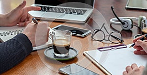 Man and woman work together on a wooden desk. Teamwork, modern business office, close up