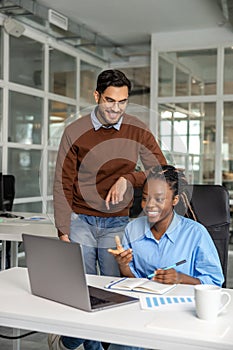 Man and woman workers discussing the moment on business project together