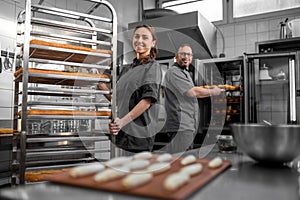 Man and woman working in a bakery and looking contented photo