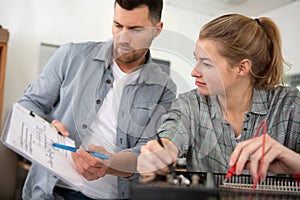 man and woman working with cables