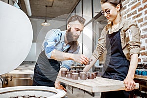 Man and woman working with ceramics at the pottery