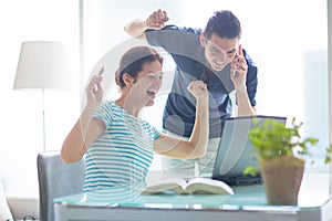 Man and woman working at laptop in modern office