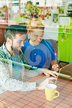 Man and woman working with laptop together