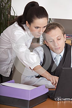 Man and woman working in office
